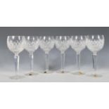 A set of six Waterford crystal cut wine glasses, the cut class bowls raised on faceted cut stems