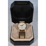 A vintage 9ct gold cased Everite wrist watch having a white enamelled face with arabic numerals to
