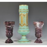 A pair of 19th Century Victorian presses purple slag glass pedestal vases of classical form together