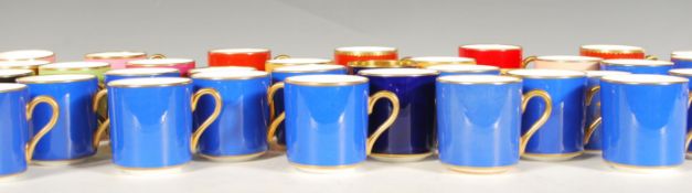 A collection of mostly Heirloom & Howard coffee cups of varying colours to include Royal blue, pink,