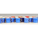 A collection of mostly Heirloom & Howard coffee cups of varying colours to include Royal blue, pink,