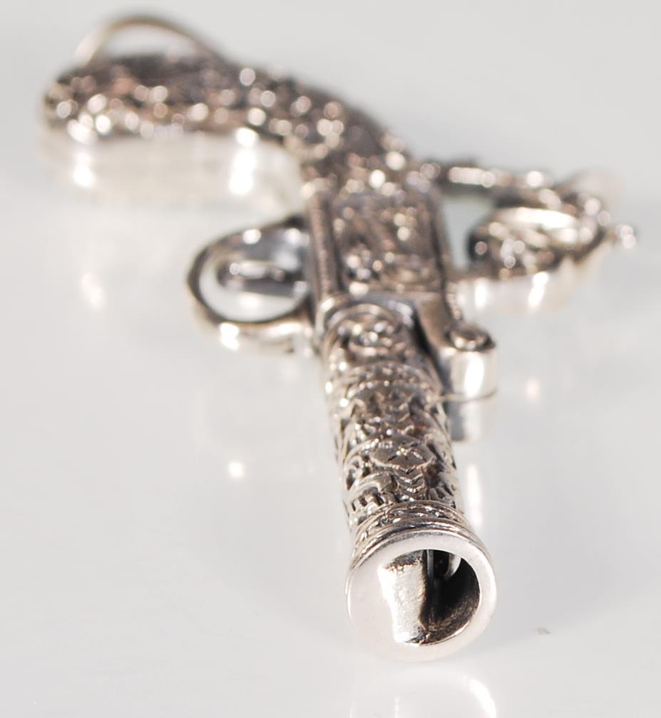 An unusual silver pendant whistle in the form of a flintlock pistol having finely engraved foliate - Image 4 of 5