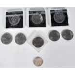 A group of five 1971 Eisenhower one dollar moon landing coins, a 1968 half dollar coin, a 1980 Her