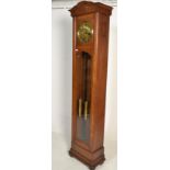A 1920's oak and brass faced longcase / grandfather clock. The hood with bevelled glass front