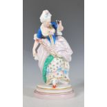 A French porcelain antique ceramic figurine in the manner of Jean Gille depicting a Georgian lady