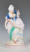 A French porcelain antique ceramic figurine in the manner of Jean Gille depicting a Georgian lady