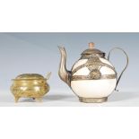 An antique oriental tea pot of small proportions having a white ceramic body with white metal