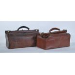 Two vintage 20th Century leather Gladstone bags, with brass fittings and fitted interiors, carry