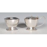 A pair of silver hallmarked cruets of curved faceted rectangular form to include a table salt with