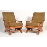 A pair of mid century retro rocking chairs. Each armchair with original moquette style fabric