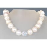 A 20th Century cultured pearl necklace having a string of 25 large pearls on a spring clasp.