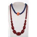 An Art Deco bakelite amber bead necklace of tapering spheres (24" long) together with lapis lazuli