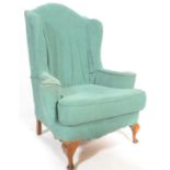 A 20th century antique style large Georgian revival wing back armchair. Raised on cabriole legs with