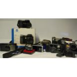 A collection of vintage 35mm cameras, lenses  and