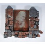 A collection of early 20th Century wooden backed copper, lead and metal printing blocks, the