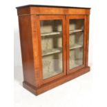 A 19th Century Victorian glazed walnut Pier cabinet bookcase. Raised om a plinth base with a