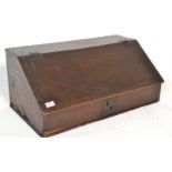 A 19th Century oak bible box of rectangular form having a hinged sloped lid with escutcheon to the