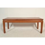 A 20th century Chinese hardwood rectangular coffee table. Raised on squared legs with carved