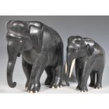 A graduating pair of vintage 20th Century ebony elephants having finely carved detailed bodies