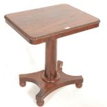 A Regency 19th century mahogany wine table. Raised on bun feet with a quadruped base having turned