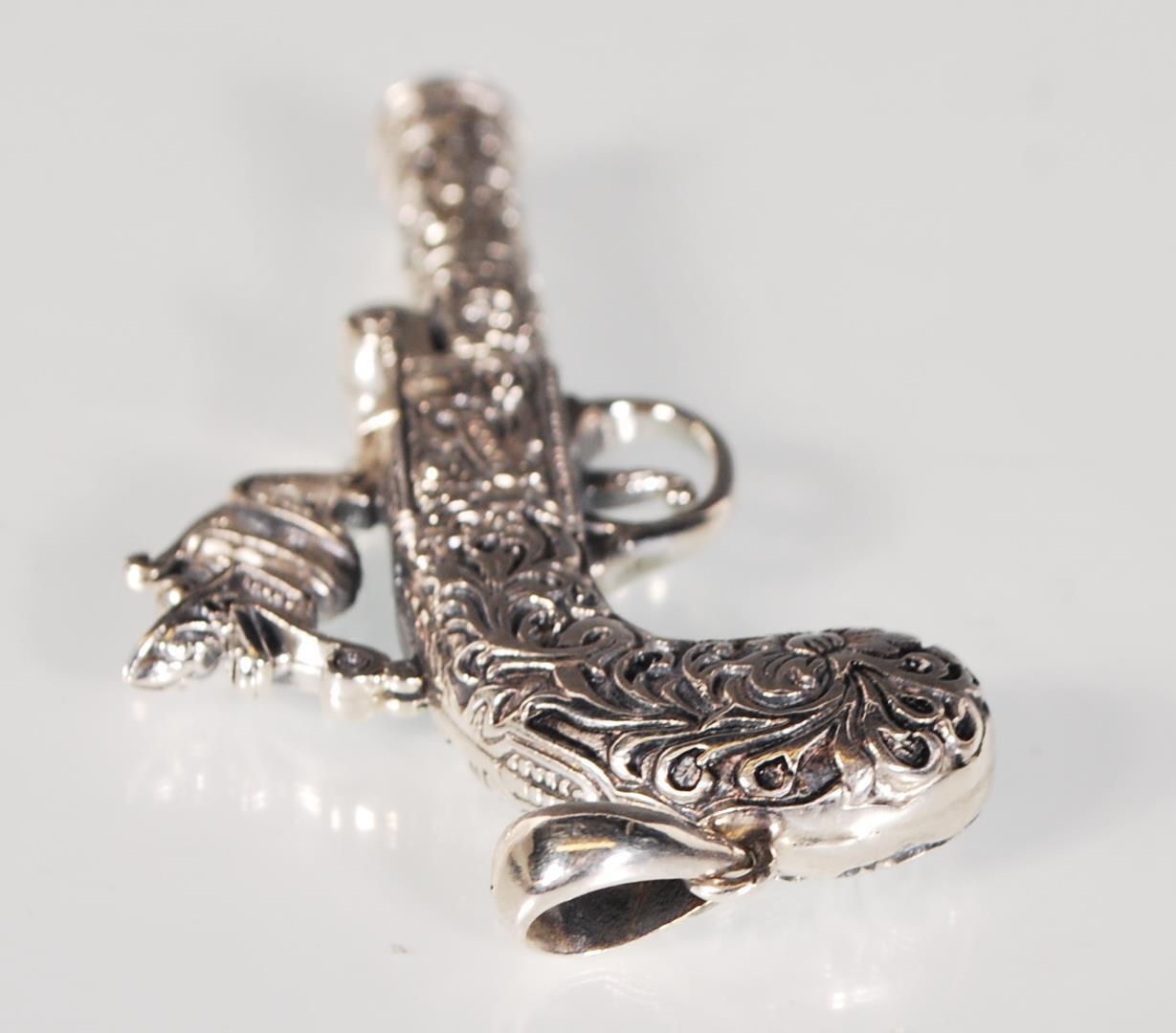 An unusual silver pendant whistle in the form of a flintlock pistol having finely engraved foliate - Image 5 of 5