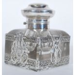 A 20th Century French silver leaded glass inkwell having banded silver mounting with reousse garland