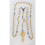 A 19th century French ivory and silver rosary prayer bead necklace. The rosary strung with a large