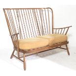 Ercol - A 20th century Windsor pattern two seater sofa settee inn beech and elm golden dawn having