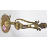 A 19th Century cast brass Pullman carriage gimbal lamp having a round wall mount with lyre shaped