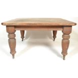 A 19th Century Victorian oak extending dining table, the rectangular surface with canted corners,