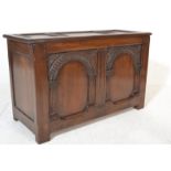 A good 17th century revival solid oak coffer having a geometric fielded panel body with hinged top