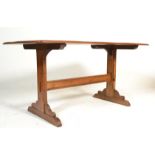 A 20th Century Ercol Old Colonial beech and elm dark wood refectory dining table raised on Windsor