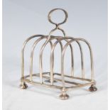 A late 19th Century Victorian silver hallmarked four section toast rack of simple form. Central