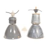 A near matching pair of large vintage industrial 20th Century factory black enamel ceiling lights.