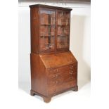 An 18th century George III mahogany bureau bookcase being raised on bracket feet with short and deep