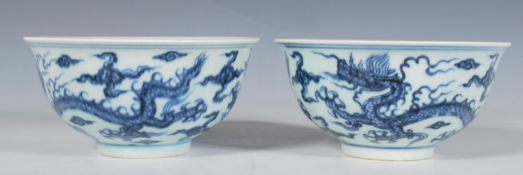 A pair of 20th Century Chinese blue and white bowls having round footed bases and flared rims having