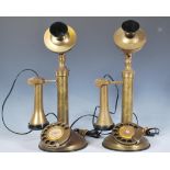 A pair of antique style stick brass telephones, ring dials to the circular bases and etched to the