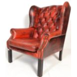 A 19th Century Victorian red leather oxblood Chesterfield wing back armchair raised on straight