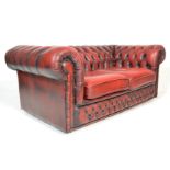 A 20th century Oxblood leather chesterfield button back sofa settee. The sofa with button backing to
