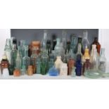 A collection of vintage and antique advertising glass bottled dating from the 19th Century to