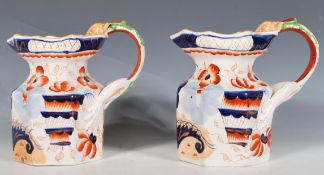 A pair of 10th Century Victorian Mason's lustre glazed hydra jugs of octagonal form with lions