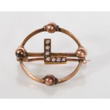 A 19th Century Victorian 9ct gold open work initial brooch of round form with orb decoration