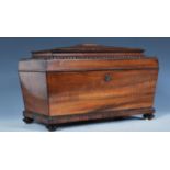 A 19th Century Georgian coromandel wood tea caddy of sarcophagus form having carved beaded banding