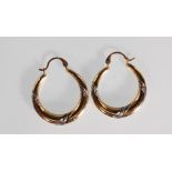 A pair of 9ct yellow and white gold hoop earrings. Stamped 375. Weighs 1g.