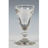 A early 19th Century Georgian cordial glass of round funnel form having a collar stem raised in a
