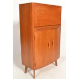 A retro 20th Century oak bureau of domed form having a fitted fall front above twin cupboard doors
