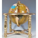 A 20th Century desk top contrasting resin ornamental terrestrial globe raised on a brass gimbal