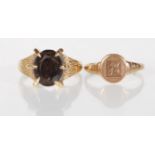 A hallmarked 9ct gold ring having a bark effect shank claw set with an oval cut brown stone (