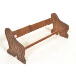 An early 20th Century fruit wood book trough of typical form having hand carved Celtic knotted