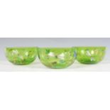 A set of three 19th Century Victorian hand blown green glass finger bowls each being hand